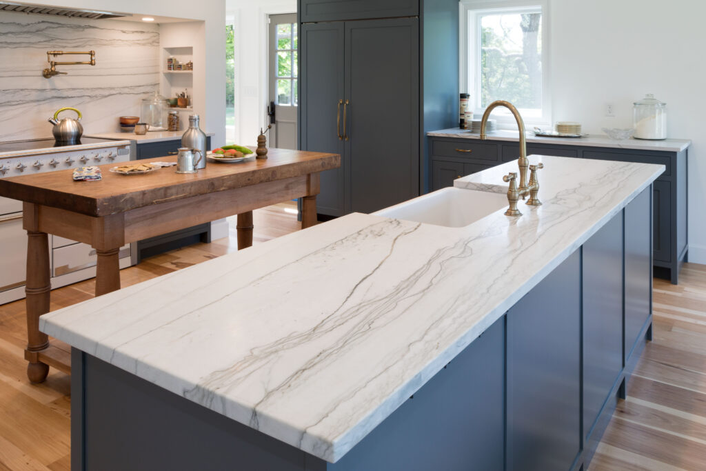 Completed Cape Ann kitchen conversion in Gloucester, MA with open floor plan, expanded sightlines, and custom white oak cabinetry