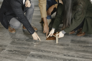Homeowners and contractor selecting wood flooring samples during a home renovation project